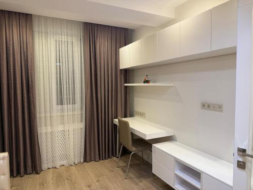 a room with a desk and a window at Relaxing 2 beds Apartment, Quiet & Comfortable in Chişinău