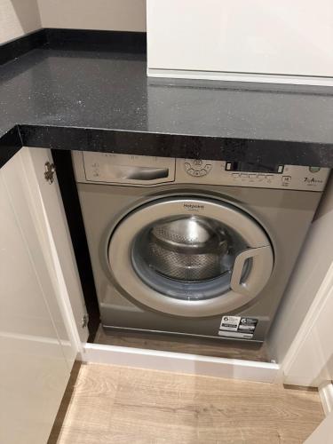 a washing machine in a cabinet in a kitchen at Relaxing 2 beds Apartment, Quiet & Comfortable in Chişinău