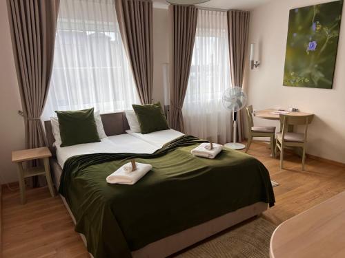a bedroom with a bed with two towels on it at 1912 Bed & Breakfast in Klaipėda