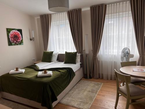 a hotel room with a bed with a table and a table at 1912 Bed & Breakfast in Klaipėda