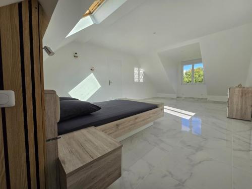 a bedroom with a bed in a white room at Appartement 150m2 avec jardin 3000 m2 