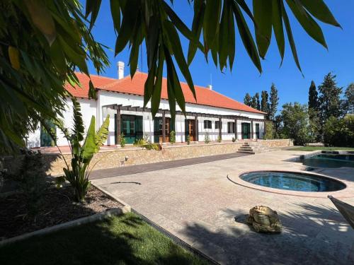 a house with a turtle in front of it at Colonial Farmhouse with Cottage - Lugar Minas da Caveira in Grândola