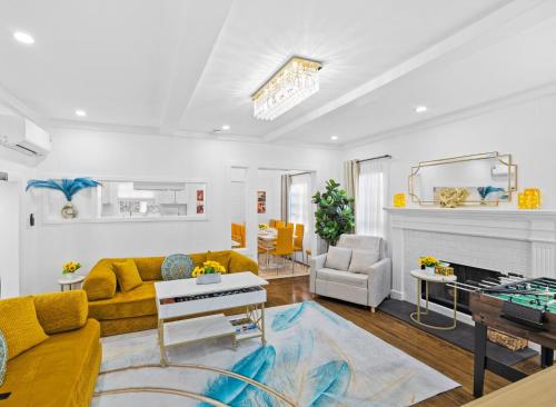 a living room with a yellow couch and a fireplace at Beautiful renovated house in Downtown Napa 4BD 2BA in Napa