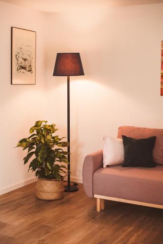 a living room with a couch and a lamp at Charme e relax a 15 min da Bobbio in Viserano