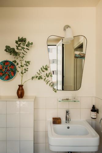 a bathroom with a sink and a mirror at Hôtel Folie - Orso Hotels in Paris