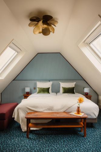 a bedroom with a bed and a ceiling fan at Hôtel Folie - Orso Hotels in Paris
