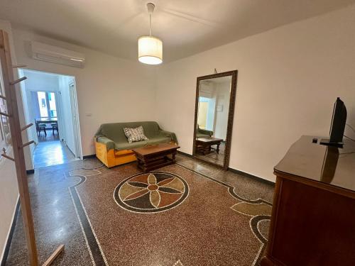 a living room with a couch and a mirror at Casa Susanna Loano in Loano