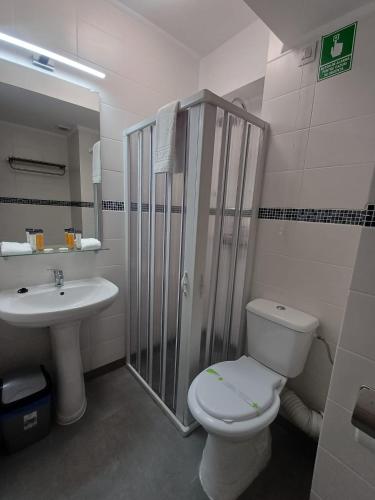 a bathroom with a toilet and a sink at G Residence in Ploieşti