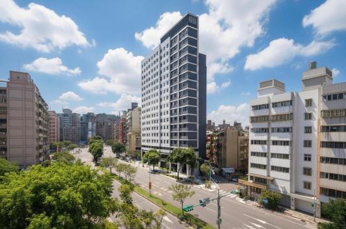 a city with tall buildings and a street at Boutech JianTan Hotel in Taipei