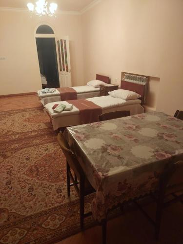 a row of beds in a room with a rug at Dilbo House in Dilijan