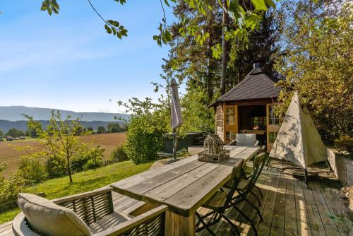 a picnic table and a tent on a deck at Ringåsen in Berg
