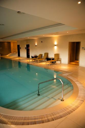 a large swimming pool in a hotel room at Best Western Lamphey Court Hotel and Spa in Lamphey