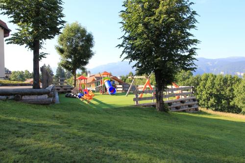 a park with a playground with at Albergo Miramonti in Lavarone