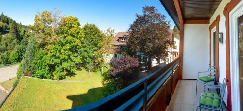 a balcony with a view of a yard at Hotel Kniebis-Stuben in Kniebis