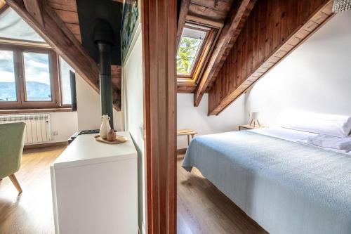 a bedroom with a bed in a room with wooden ceilings at Las casitas de mache - MODESTO in Cerler