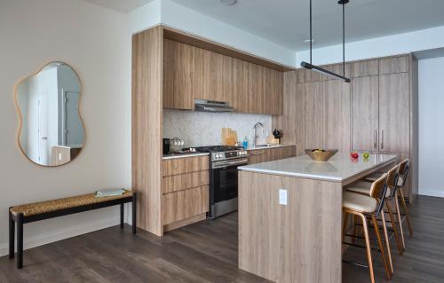 a kitchen with wooden cabinets and a counter top at Lux Apts with Lake Views and Top Amenities in Chicago