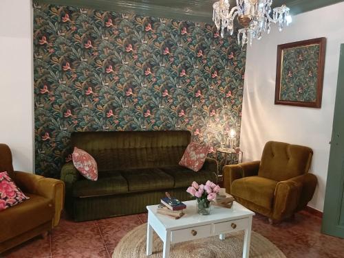 a living room with a couch and a table at A Encantada in Alqueve