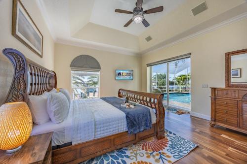 a bedroom with a bed and a ceiling fan at Plunge into Joy & Bayfront Magic at Seaside Escape - Villa Seabird in Apollo Beach