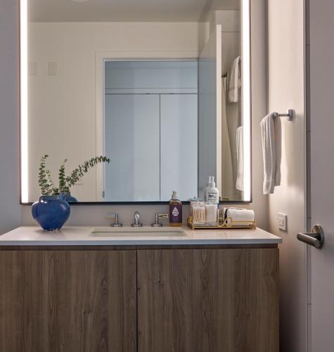 a bathroom with a sink and a large mirror at Lux Apts with Lake Views and Top Amenities in Chicago