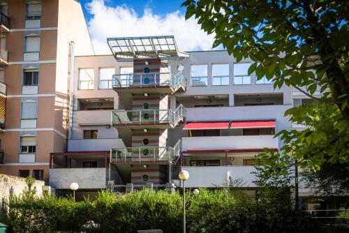 an apartment building with a balcony on the side of it at Piazzi House in Sondrio