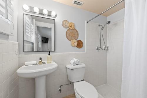 a white bathroom with a sink and a toilet at Summer Lovin in Bailey Hall