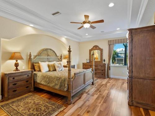 a bedroom with a bed and a ceiling fan at Treasure on the Canal in Bailey Hall