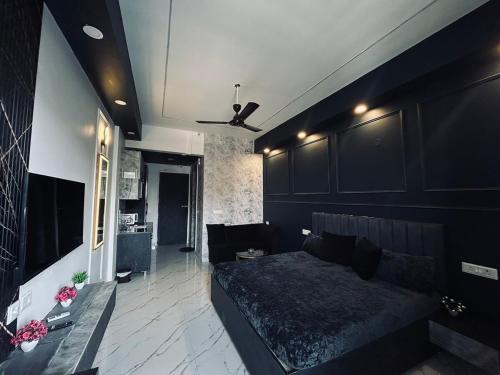 a living room with a bed and a couch at Elite BnB, High Rise with city view in Ghaziabad