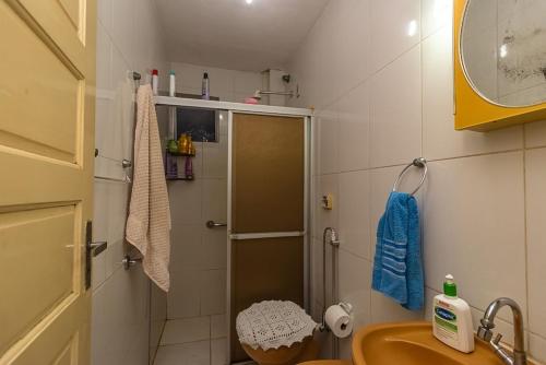 a small bathroom with a shower and a sink at Condomínio Aldeia do Rádio in Carmo