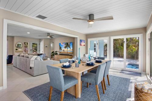 a dining room and living room with a table and chairs at Siesta Dreamin' in Siesta Key