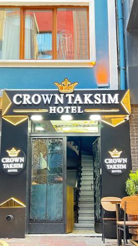 a building with a sign for a crown palace hotel at Crown Taksim Hotel in Istanbul