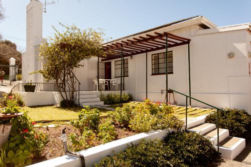 a house with a garden in front of it at 4 Rothman Street B&B in Graaff-Reinet