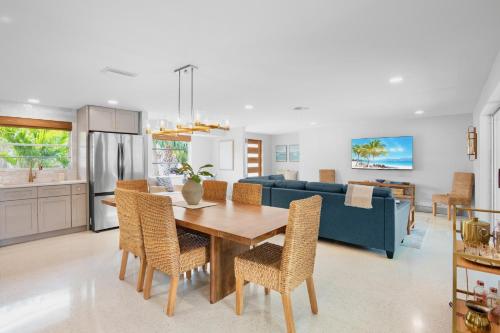 a kitchen and living room with a wooden table and chairs at Coastal Charm in Bailey Hall
