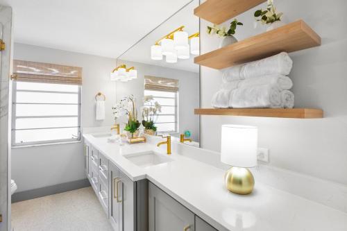 a bathroom with a sink and a mirror at Coastal Charm in Bailey Hall