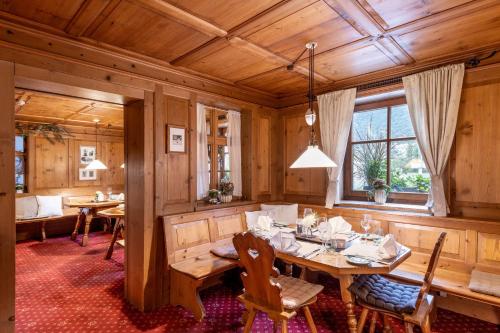 a dining room with a table and chairs at Relax & Vitalhotel Adler in Schruns-Tschagguns