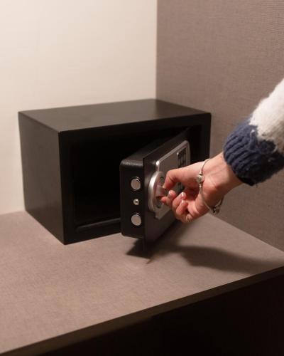 a person is putting their hand into a safe at Coscaña Uyuni Hotel by Toloma in Uyuni