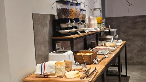a long table with bread and other foods on it at HOTEL CONCEPT BARILOCHE in San Carlos de Bariloche
