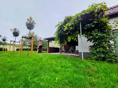 a yard with green grass and a house with a gazebo at Schaefer Apartments - Residence Gardenview in Mühlheim