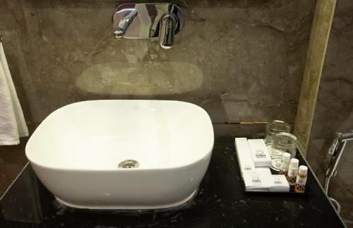 a bathroom with a white sink in a bathroom at Hotel East End Delhi Aiport in New Delhi