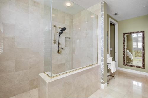 a bathroom with a shower with a glass door at Penthouse Paradise in Siesta Key