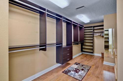 a walk in closet with purple cabinets and a rug at Penthouse Paradise in Siesta Key