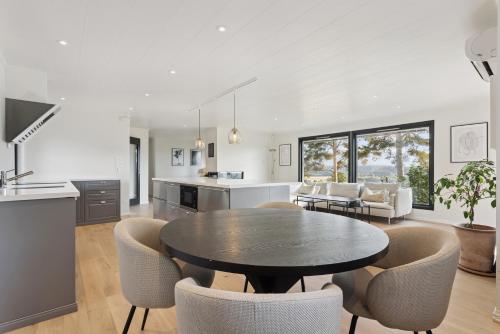 a kitchen and living room with a table and chairs at Ringåsen in Berg