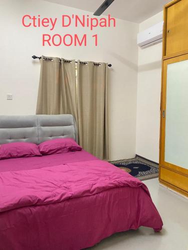 Postel nebo postele na pokoji v ubytování Ctiey D'Nipah