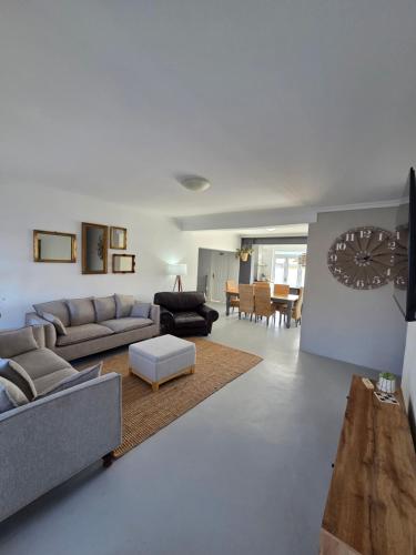 a living room with a couch and a table at Stoepstories in Yzerfontein