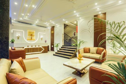 a lobby with couches and a table and stairs at Hotel East End Delhi Aiport in New Delhi