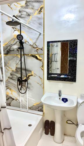 a bathroom with a sink and a tub and a toilet at HostelGoldCity in Kokand