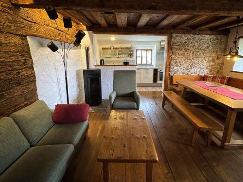 a living room with a couch and a wooden table at Attersee-Chalet Angermann Familie Spalt in Steinbach am Attersee