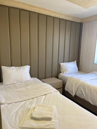 a room with two beds with towels on them at Azmal Hotel & Suites in Irbid