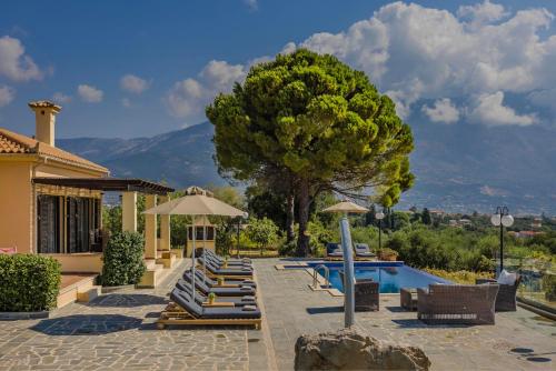 a group of lounge chairs next to a swimming pool at Saluto by Vintage Travel in Spartia