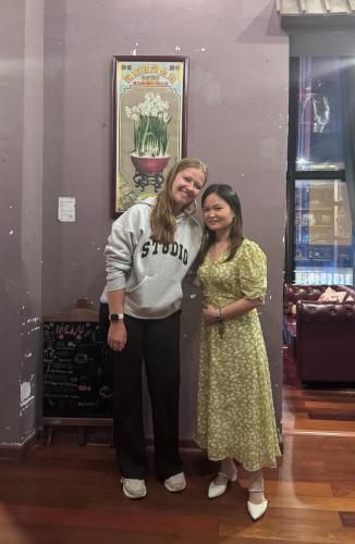 two women standing next to each other in a room at Zhangjiajie Wangyi Inn in Zhangjiajie