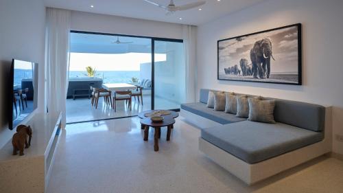 a living room with a couch and a table at One Ocean Hotel Apartments by Nest & Nomad in Msambweni